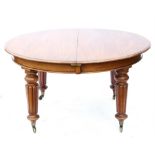 Victorian mahogany extending dining table, with three extra leaves, on turned and reeded legs and