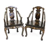 Pair of Chinese black lacquered and gilt decorated armchairs, with landscape scenes,