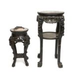 Two late 19th/early 20th century marble topped carved hardwood plant stands with foliate decoration,