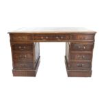 20th century mahogany pedestal desk, with green leather writing surface above two short and one