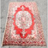Vintage Iranian rug with central medallion on a red ground within a floral border, 247 x 153cm