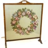 20th century tapestry fire screen, decorated with floral wreath, initialled MC and dated 1968 lower