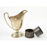 A silver helmet shaped cream jug Sheffield 1913, Walker and Hall, and 2 silver napkin rings 6 ozs