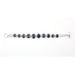 Modern bracelet, set with ten oval checkerboard cut sapphires, set in silver, t-bar clasp,