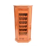 Hardwood corner wine rack, with racks for 18 bottles of wine above single drawer on plinth base,