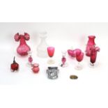 Various cranberry glass vases, a clear decanter, MG car badge