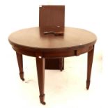 Mahogany D-end extending dining table, with one extra leaf, on tapering legs and castors,