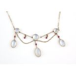 Early 20th C moonstone and ruby fringe necklace, designed as three moonstone drops,