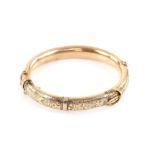 Edwardian gold buckle bangle, engraved with scrolling motif and ivy leaf detailing,