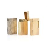 Three S T Dupont lighters, two in gilt metal, one with diamond decoration no. Q4PU46 and one with