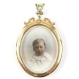 Antique open locket pendant, central oval glazed panel with coloured photographs of a baby boy and