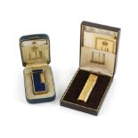 Two Dunhill lighters, one blue enamel rectangular shaped one that's gold plated, in original box