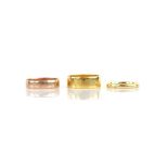 Three gold rings, including a 6.2mm wedding ring, in 22 ct, ring size M, a 2.2mm wedding band,