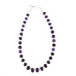 Amethyst necklace, with thirty one graduated cabochon amethysts, set in silver, length estimated 48