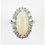 Opal and diamond cluster ring, central oval cabochon cut opal, estimated weight 2.35 carats,
