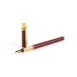 Les Must De Cartier fountain pen, with a red lacquer case and lid, with gold plated detail and the