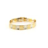Bi-colour gold fancy link bracelet, with engraved and polished concave gold links,