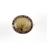 Georgian moss agate ring, central moss agate panel 13 x 11mm, set with a border of amethysts,
