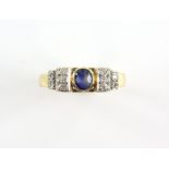 Sapphire and diamond dress ring, with a central oval cut sapphire, with diamond set ribbon style