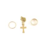 Two gold rings, one wide with engraved detail, 7.4mm width, another court ring, size T and a cross