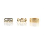 Three gold rings, including a Claddagh ring, designed as multiple Claddagh motifs to the full hoop,