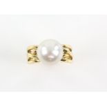 Abstract pearl cross over ring, pearl measuring 11.5mm in diameter, mount stamped 18 ct,
