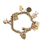 Vintage charm bracelet, flat curb links with a heart padlock clasp and safety chain,
