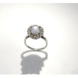 Star sapphire and diamond cluster ring, central oval cabochon cut sapphire, estimated weight 6.