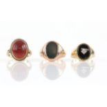 Three gem set rings, including a bloodstone signet ring, ring size R1/2, an onyx and diamond signet