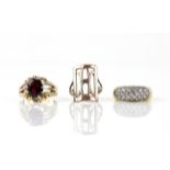 Three rings, including a single stone garnet ring, in 9 ct, ring size W, a multi stone cubic