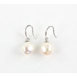 A pair of pearl earrings, baroque cream pearls measuring an estimated 11.67 x 10.