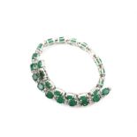 Emerald and diamond bracelet, twenty-six oval cut emeralds weighing an estimated total of 9.