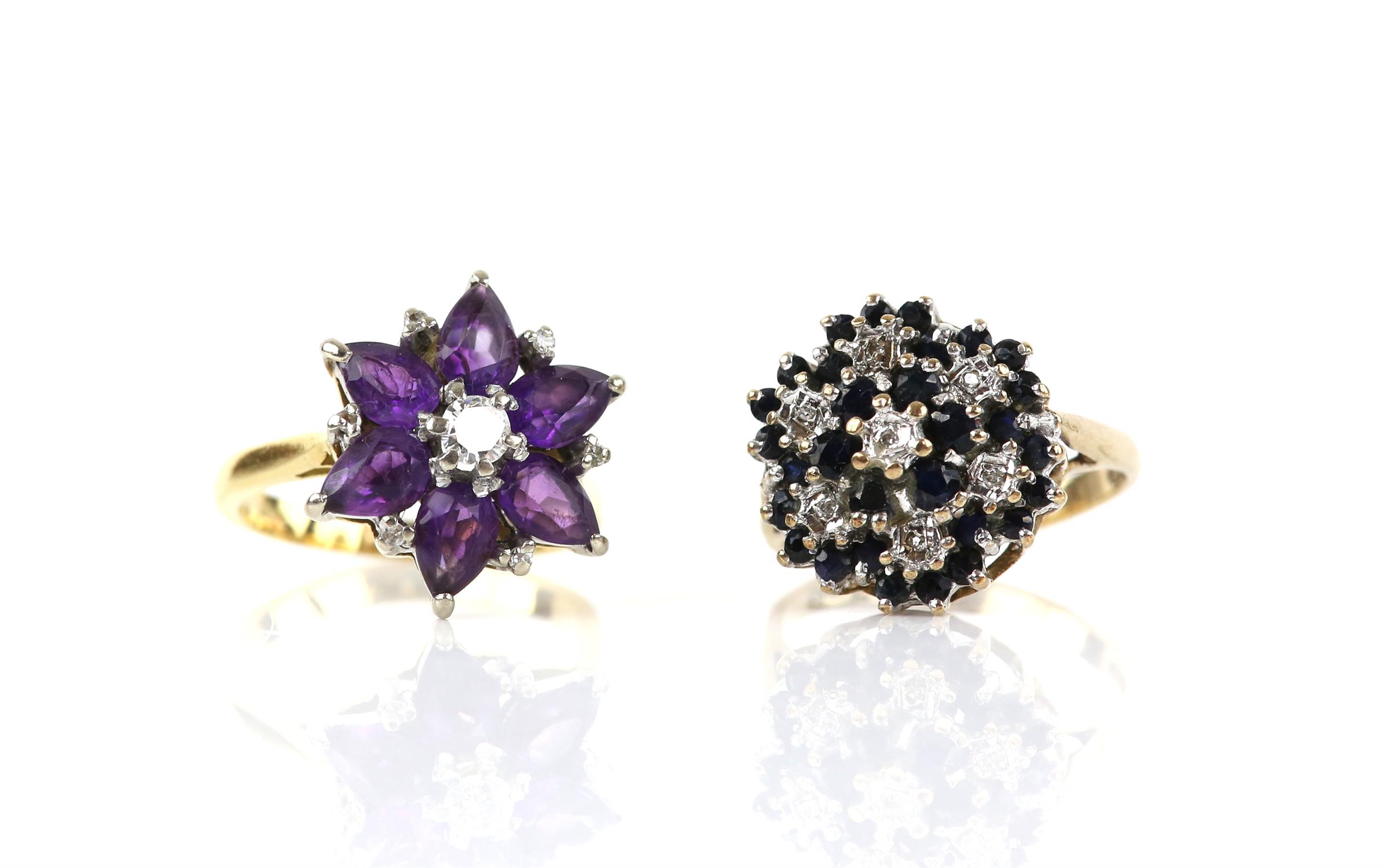 Two vintage floral cluster rings, including an amethyst and diamond cluster, with a central round