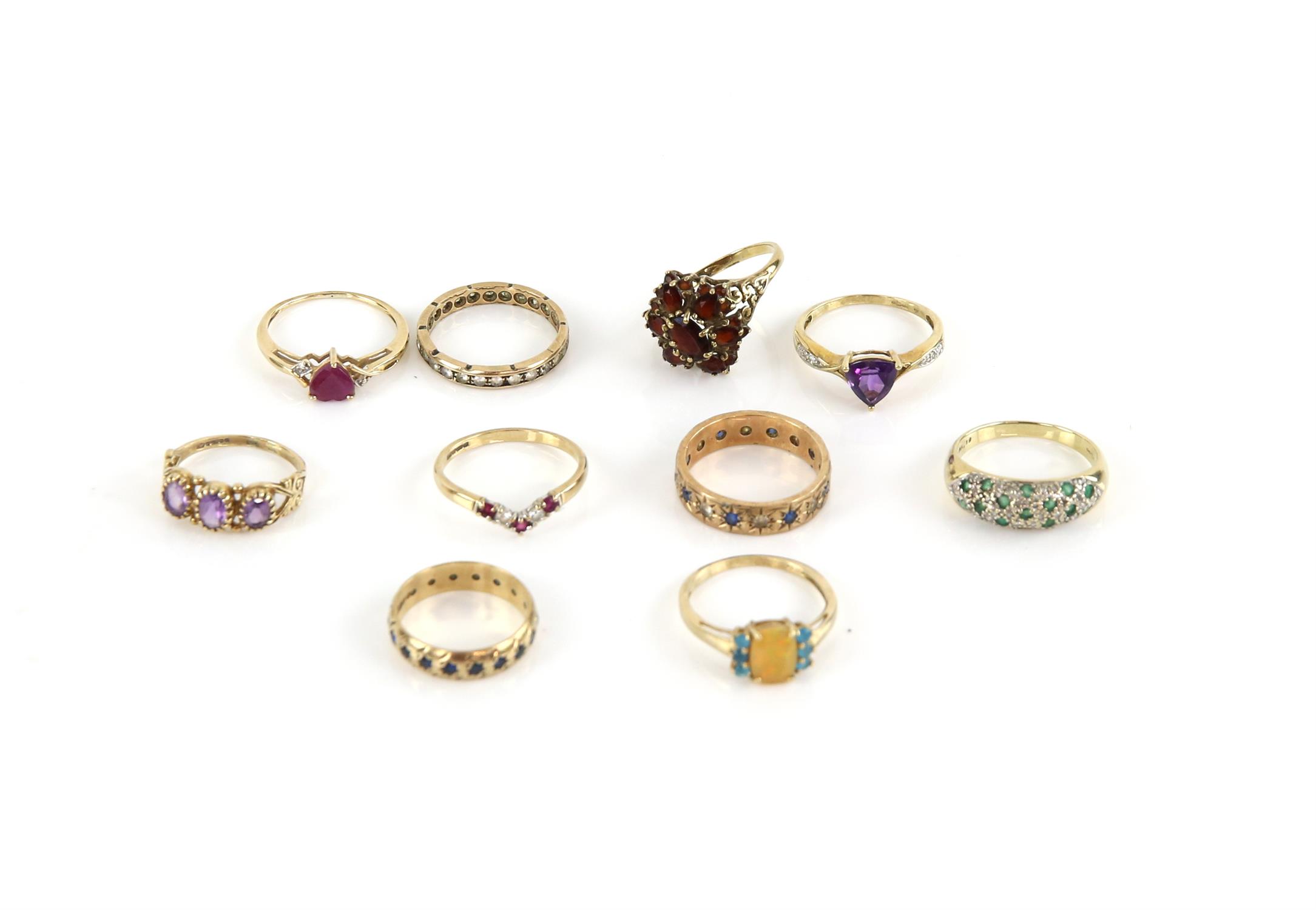 Ten gem set rings, including a garnet cluster ring, size N, a heart shaped ruby ring, size N,