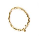 Fancy link gold bracelet, comprised of interlocking plain polished gold, and hammered effect gold