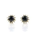 Pair of single stone sapphire stud earrings, in a floral claw set 18 ct mount, post and screw back