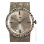 Omega, a Ladies white gold dress watch, diamond set bezel, estimated total diamond weight 0.