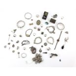 Antique mainly silver costume jewellery to include bangles, brooches, large and small lockets,