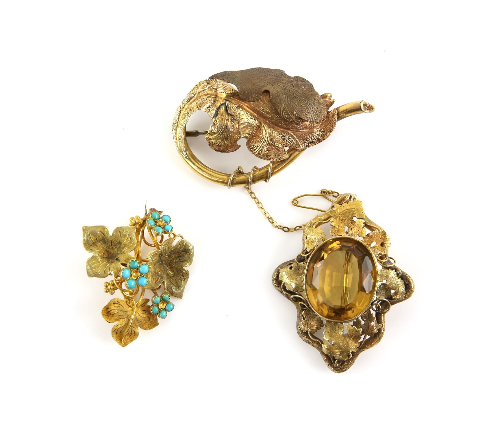 Three antique brooches, one Victorian vine leaf brooch centrally set with a large oval cabochon cut