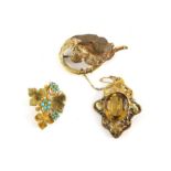 Three antique brooches, one Victorian vine leaf brooch centrally set with a large oval cabochon cut