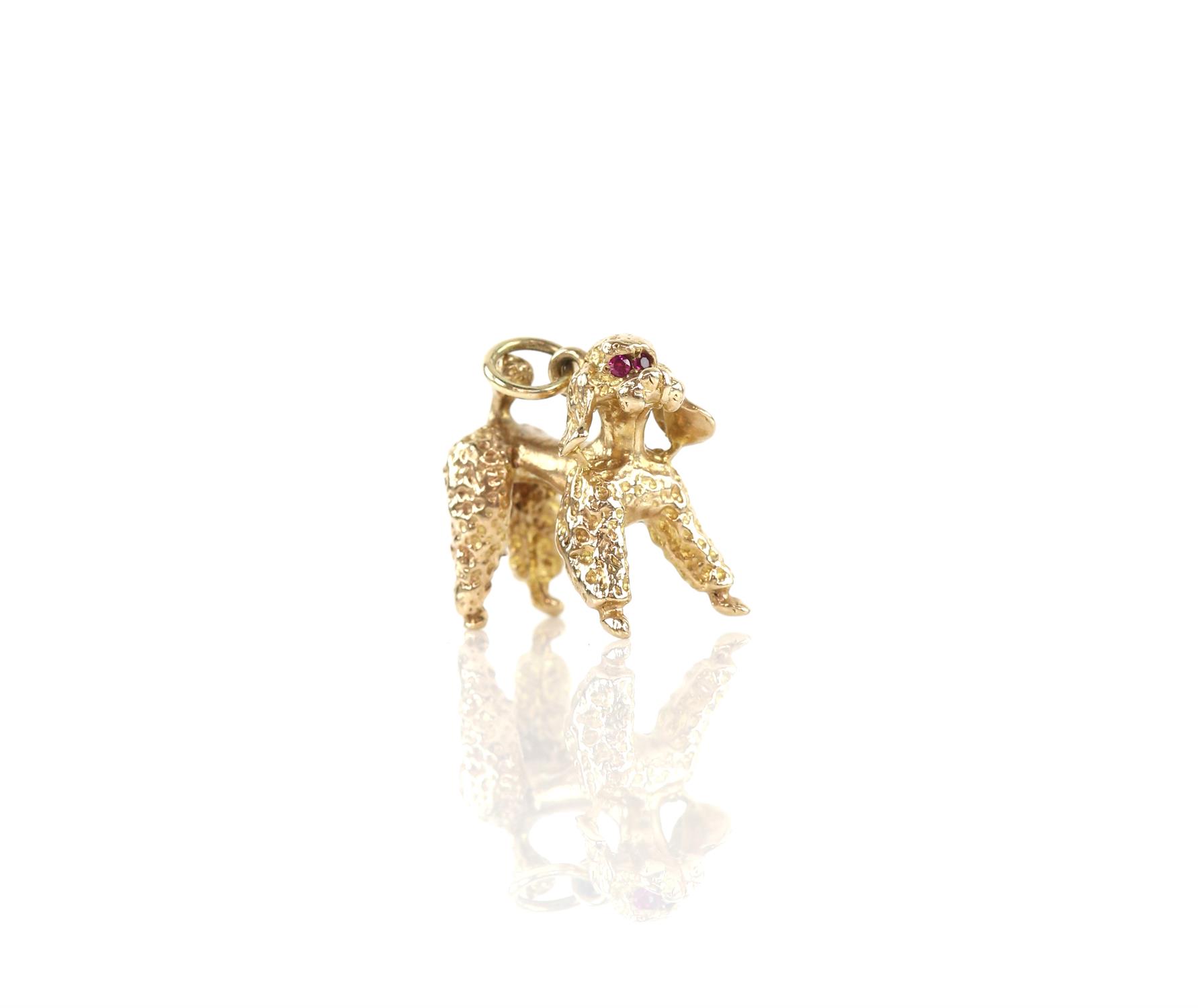 Poodle pendant charm with synthetic ruby eyes in 18 ct, with textured and polished gold detail,