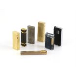 A collection of seven lighters, including Dunhill Tallboy Cartier Licence, in a gilt metal case