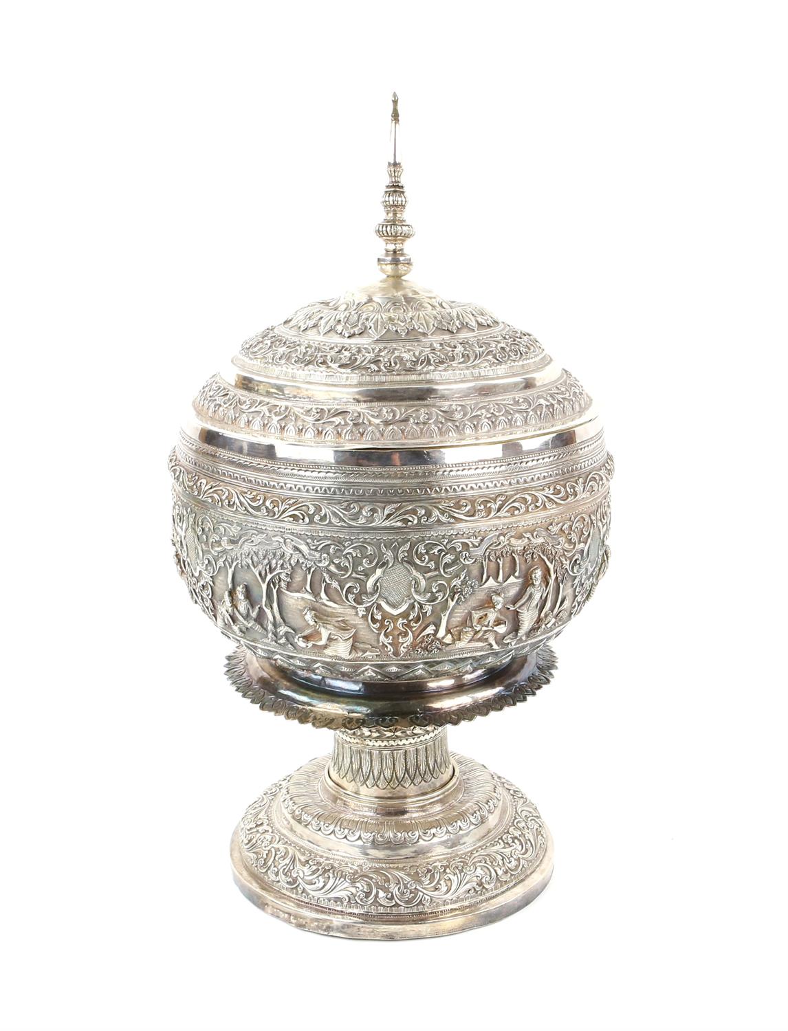 Burmese white metal pedestal bowl and cover with embossed figural and scrolling foliate decoration,