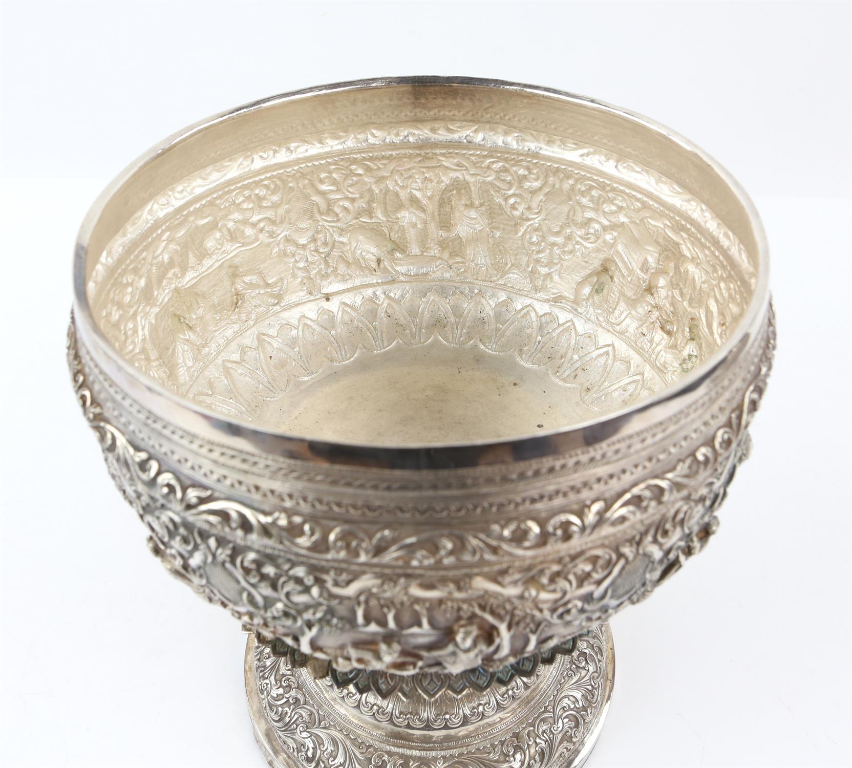 Burmese white metal pedestal bowl and cover with embossed figural and scrolling foliate decoration, - Image 3 of 6