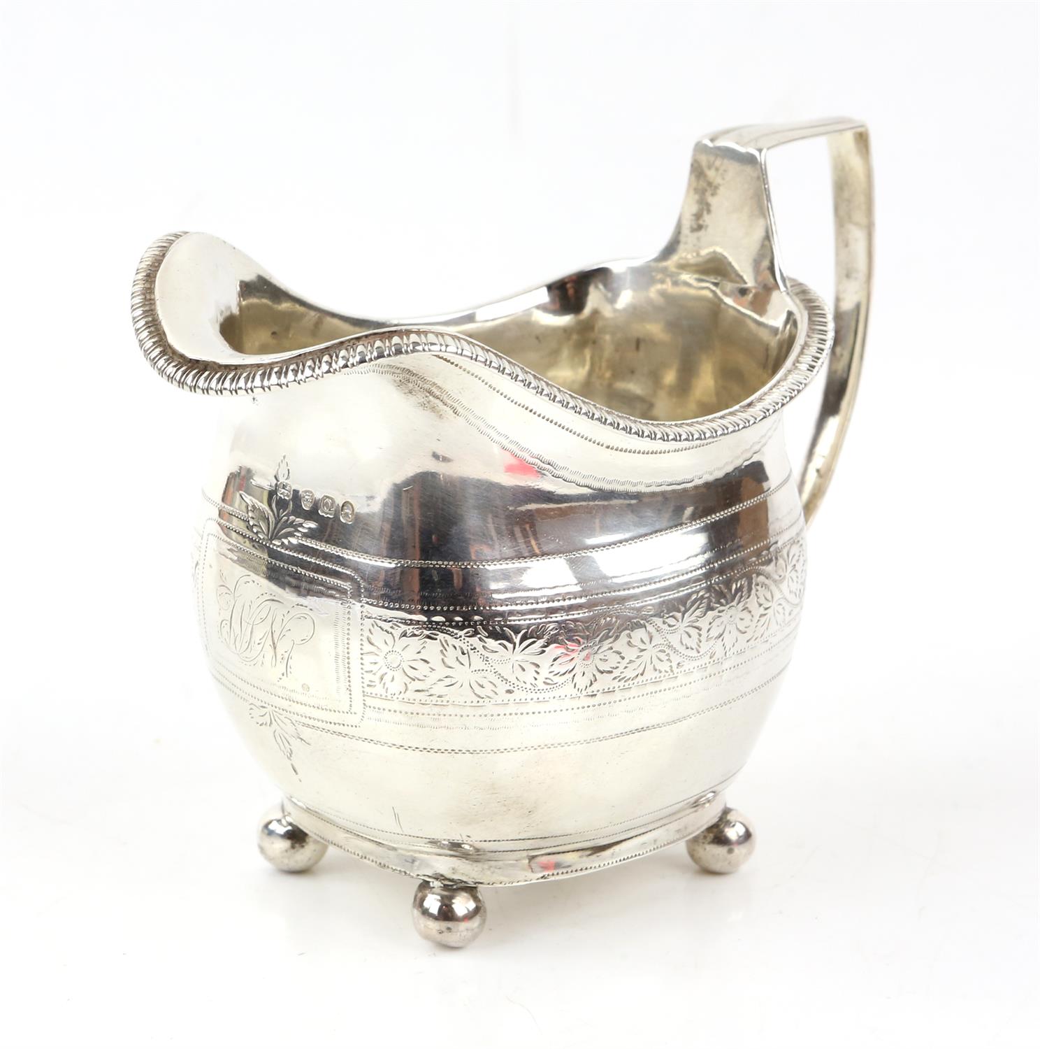 George III oval shaped silver cream jug with bright cut foliate scroll band, London 1811,