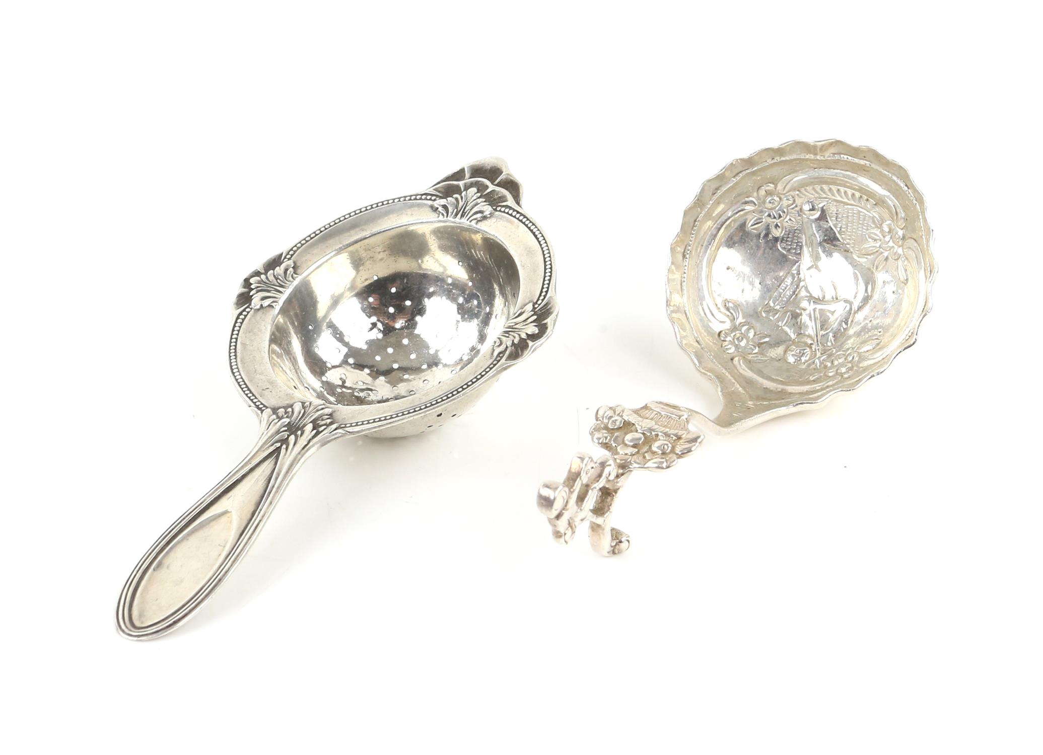 Continental silver caddy spoon and an 830 grade silver tea strainer