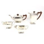 George V silver four piece tea service,comprising teapot, hotwater jug, cream jug and sugar bowl,