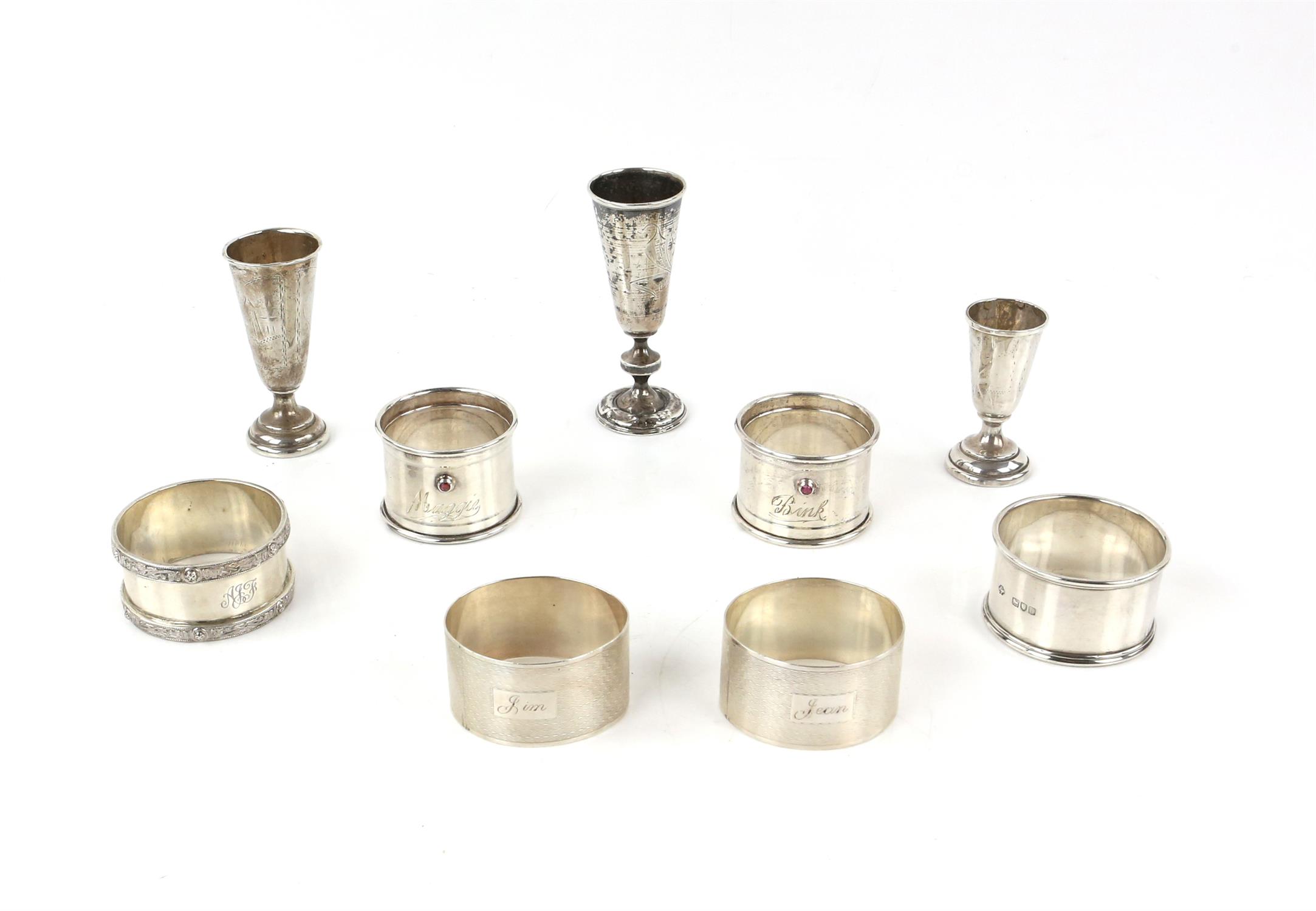Russian silver tot cup on knopped stem, two smaller cups and six silver napkin rings in avariety of