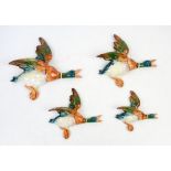 Set of four graduated Beswick Flying ducks, No 596/1/2/3/4, largest H25cm W26cm, smallest H14cm