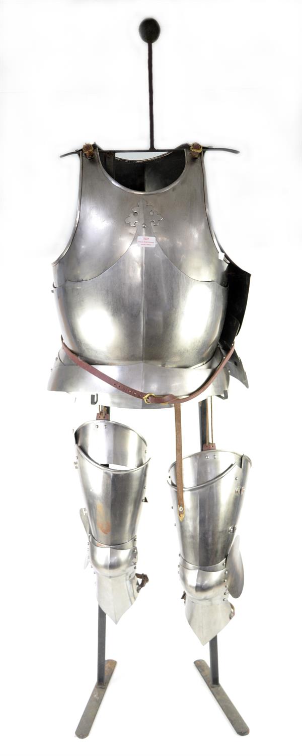 Reproduction partial suit of steel armour, breast plate, back plate, cuisse and greave, on stand